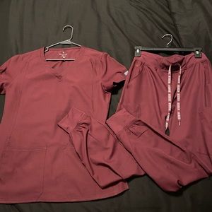 MEDCOUTURE scrubs size small in color wine.